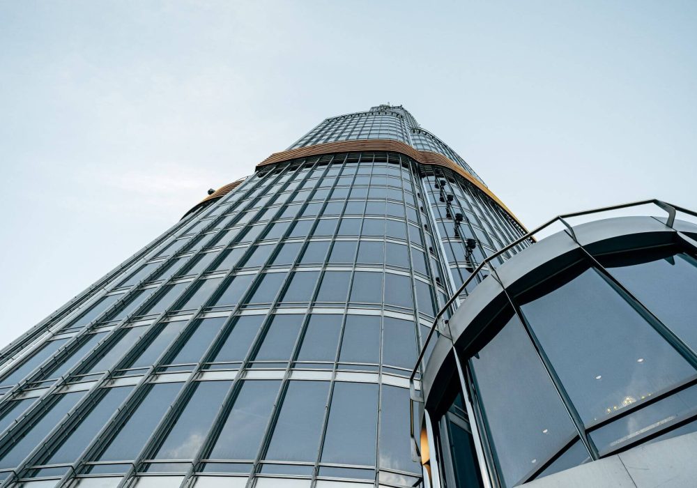 tall-glass-building-against-blue-sky-view-from-th-2023-11-27-05-02-25-utc.jpg